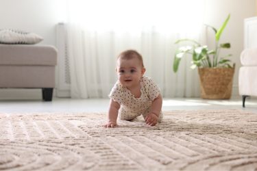 Baby crawling in carpet