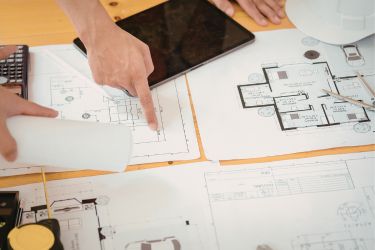 Architect pointing at floor plans