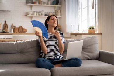 Woman feeling hot in her living room
