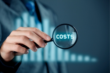 Hands holding a magnifyer that says "Cost"
