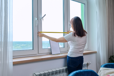 Woman measuring her windows