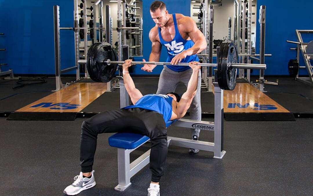 man bench pressing - How Much Does A Bench Press Bar Weigh