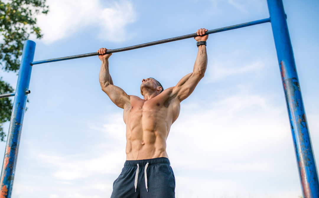 man on a pull up bar -  Do Pull Ups Work Chest