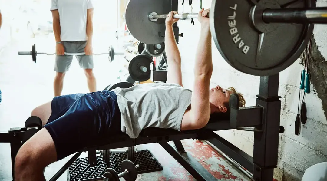 young boy doing benchpress - Average Bench Press By Age 16