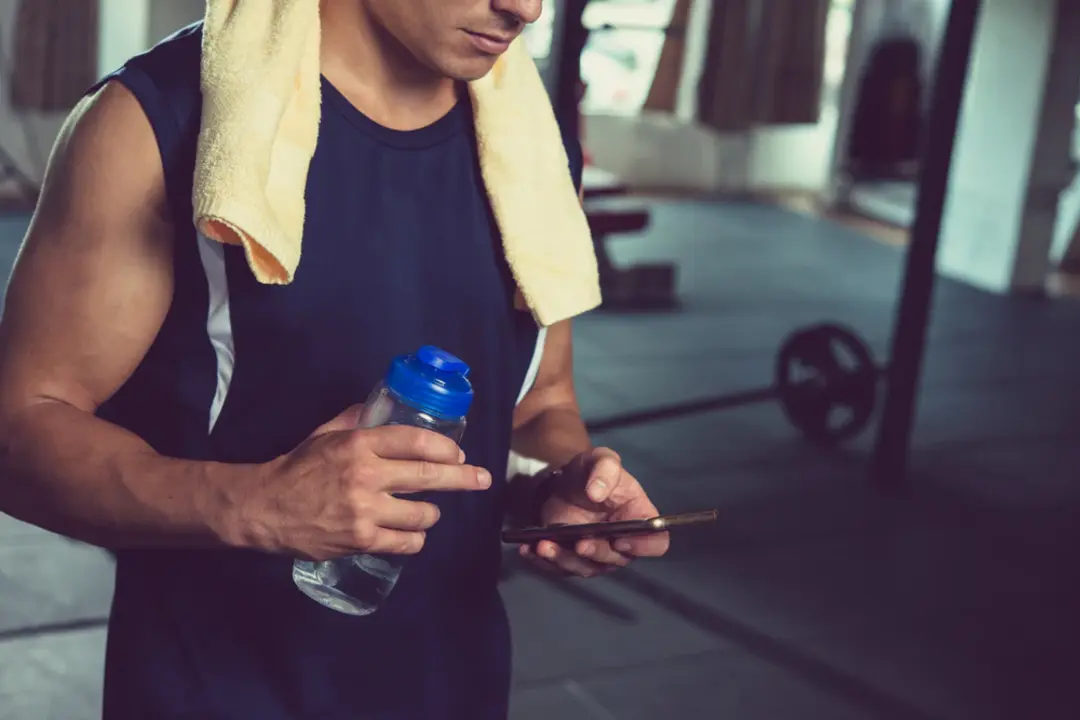 man using his phone - Best Gym Workout App