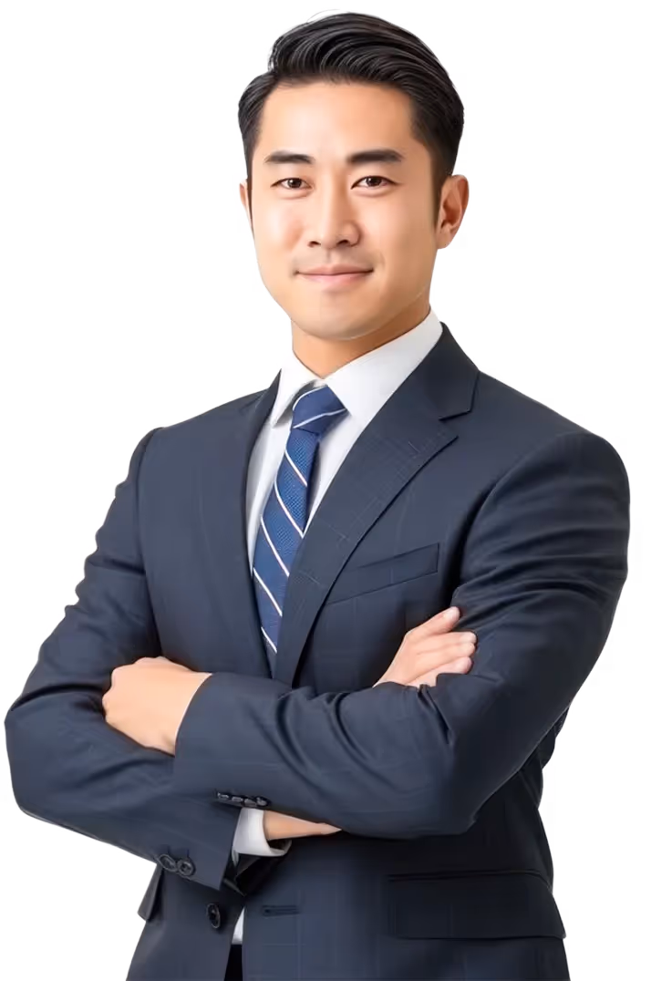 Confident man wearing navy suit and striped tie with arms crossed.