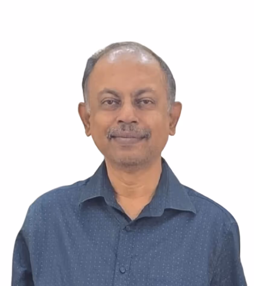 Middle-aged man with short hair and mustache smiling, wearing a dark blue button-up shirt.
