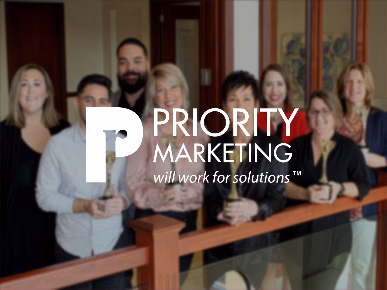 The Priority marketing team with their logo.