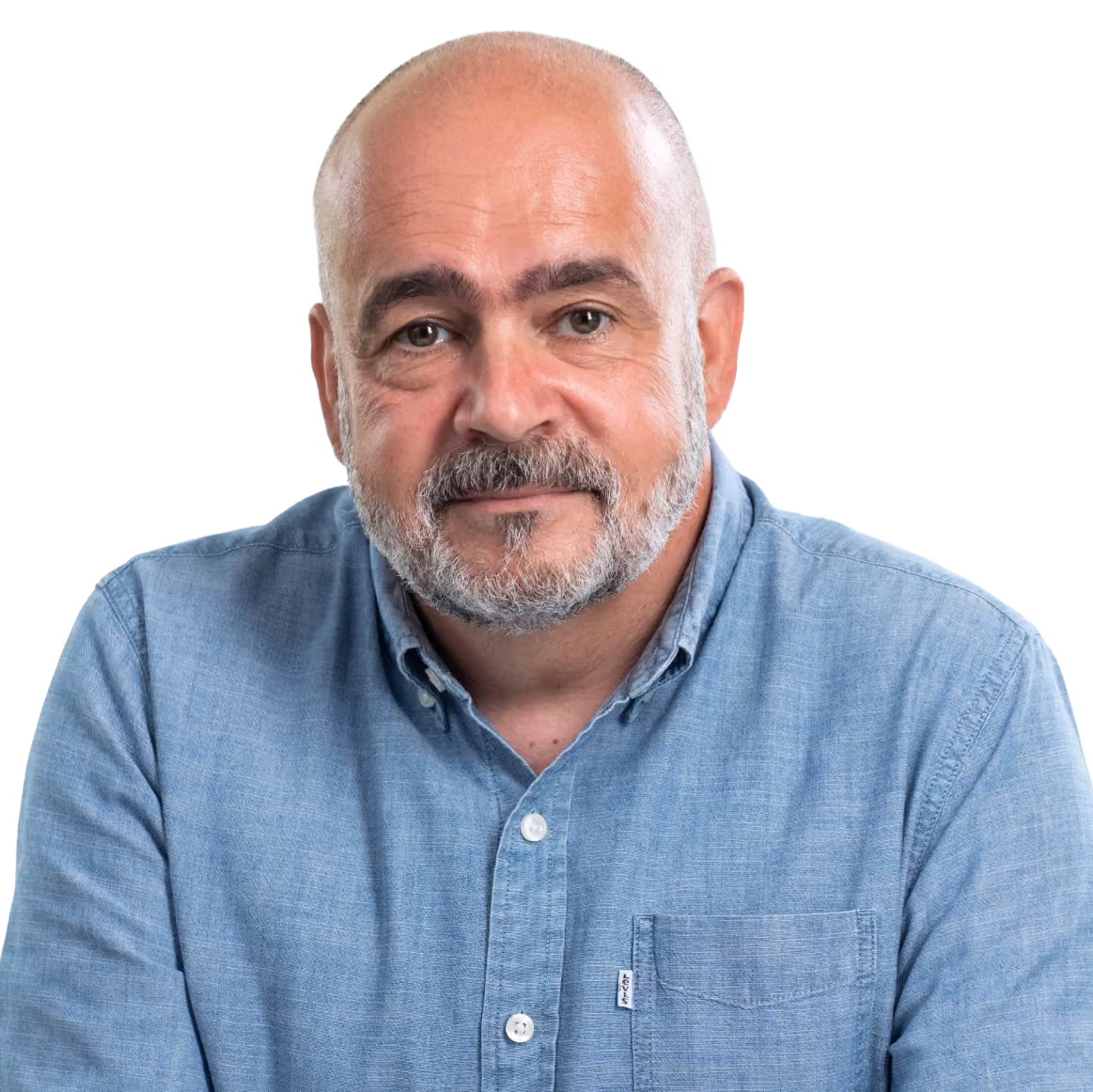 Smiling middle-aged man with beard in a blue button-up shirt against a light background.