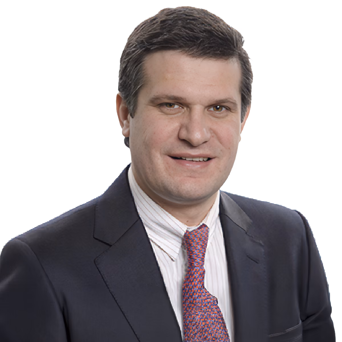 Man with short dark hair wearing a black suit, white shirt, and red patterned tie smiling.