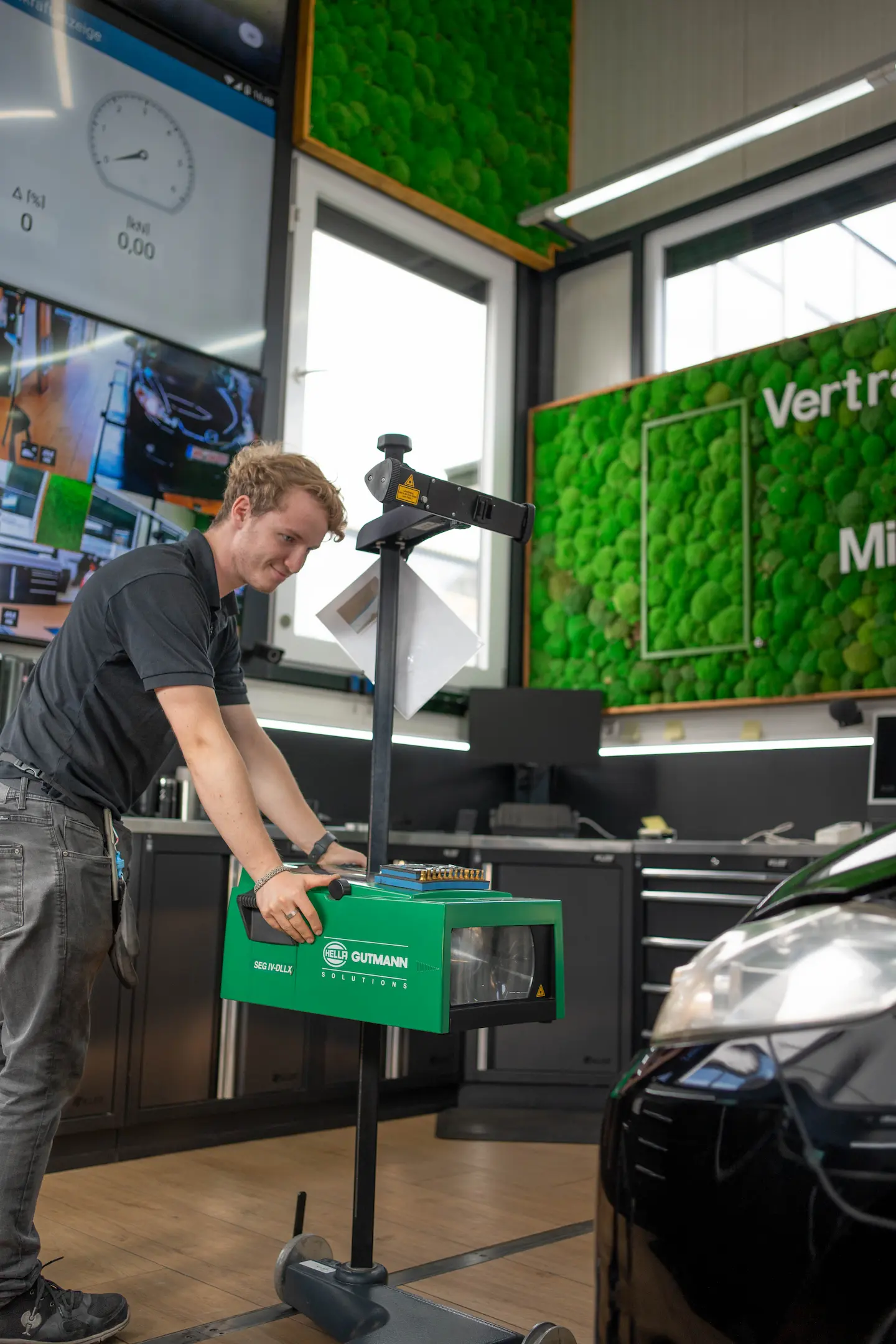 Sven von KLEE-sicher prüft ein Fahrzeug mit dem Lichteinstellgerät in der TÜV Prüfstelle Stuttgart-Sommerrain – präzise Hauptuntersuchung und Abgasuntersuchung (HU/AU) für Deinen TÜV Termin in Stuttgart