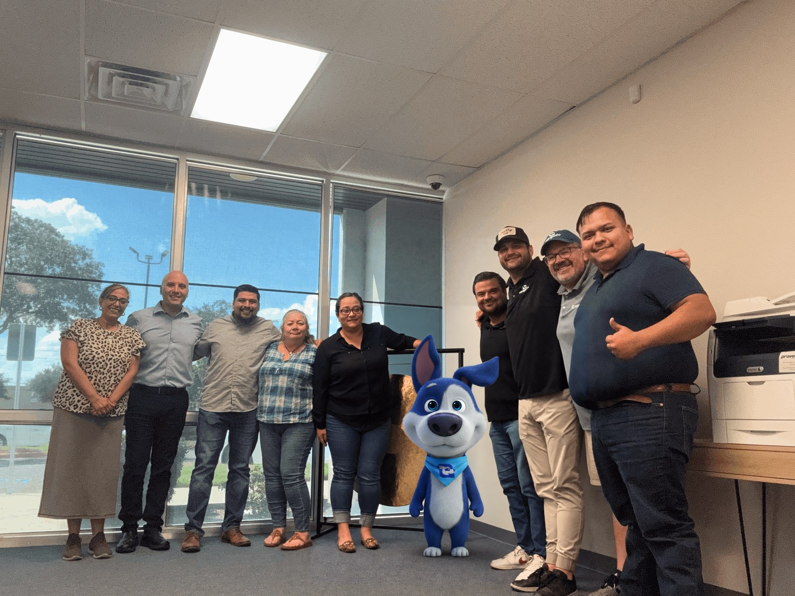 The Steam Logistics and Cargado teams together at Steam's Laredo office, with the Cargado mascot