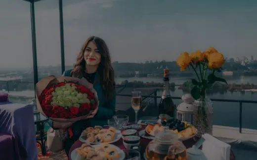 there is a woman holding a bouquet of flowers on a table