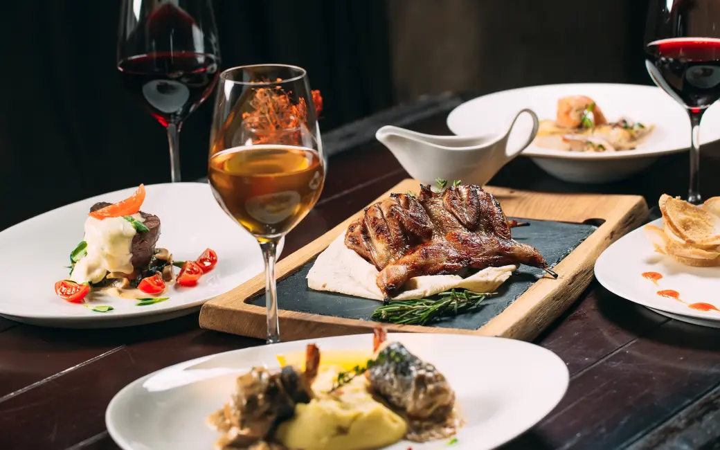 several plates of food and wine are on a table