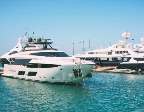 boats docked in a harbor with a blue sky in the background