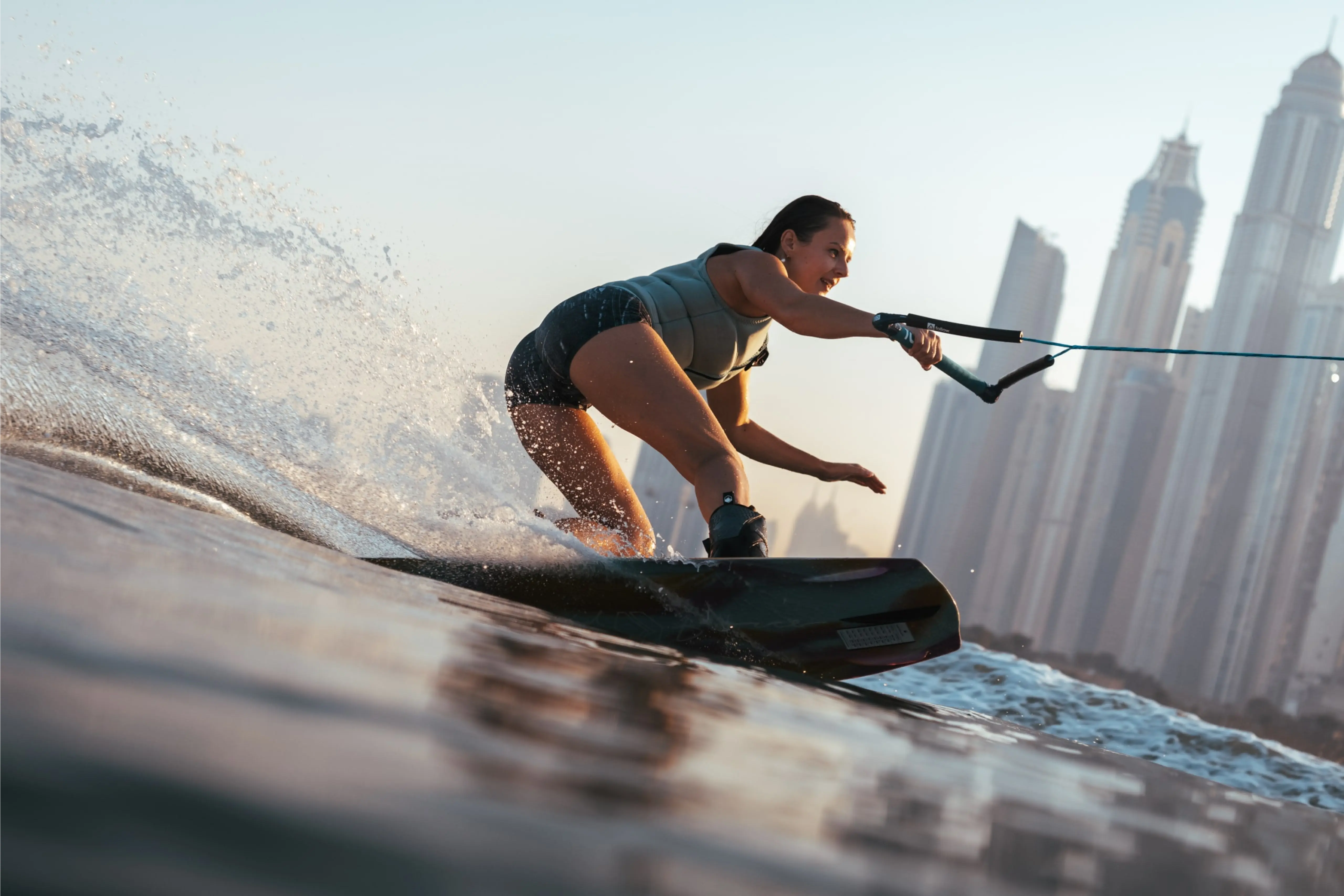 woman on a wake board riding a wave in the ocean