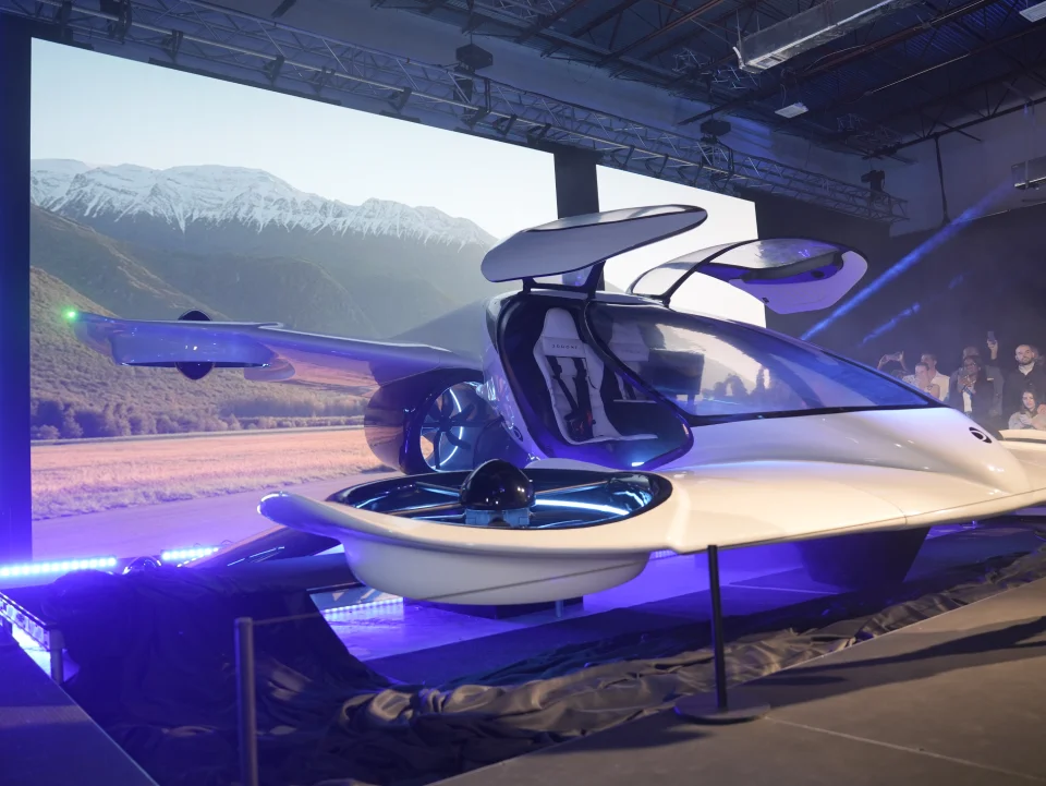 Engineers assembling the fuselage of a Doroni aircraft prototype in a workshop.