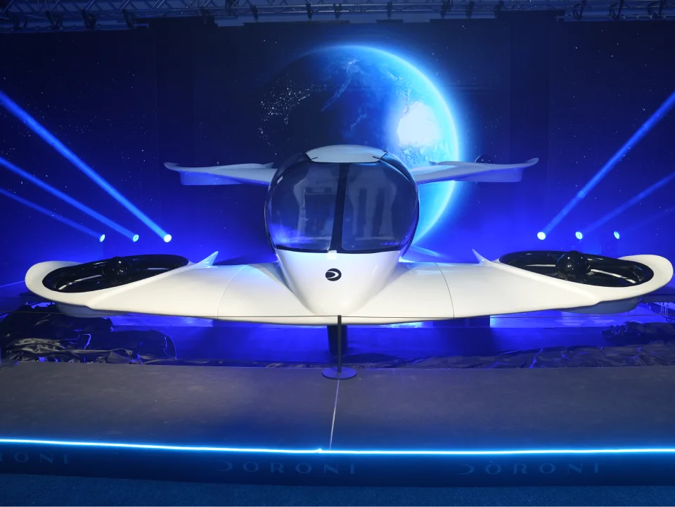 Engineers assembling the fuselage of a Doroni aircraft prototype in a workshop.