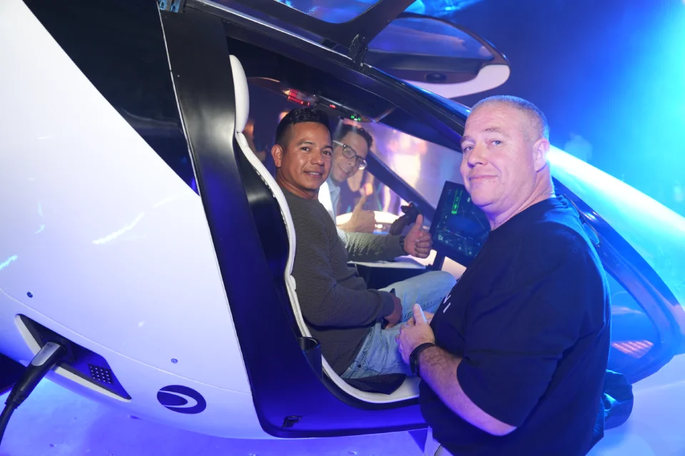 Engineers assembling the fuselage of a Doroni aircraft prototype in a workshop.