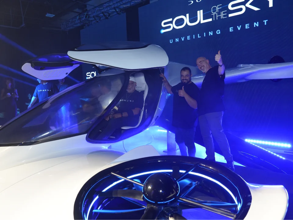Engineers assembling the fuselage of a Doroni aircraft prototype in a workshop.
