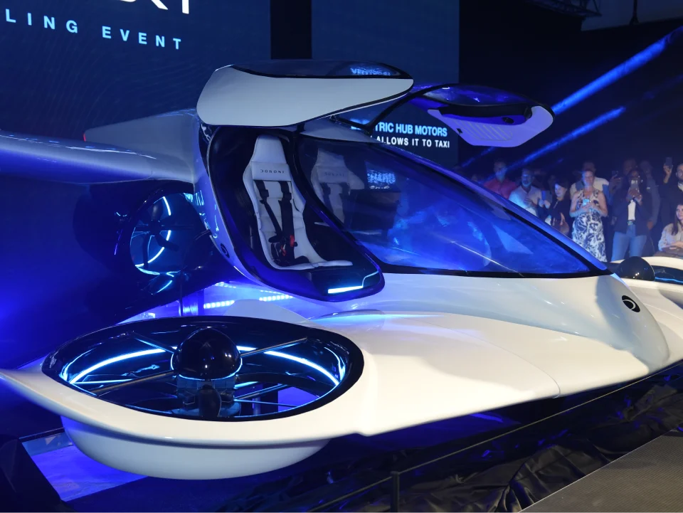 Engineers assembling the fuselage of a Doroni aircraft prototype in a workshop.