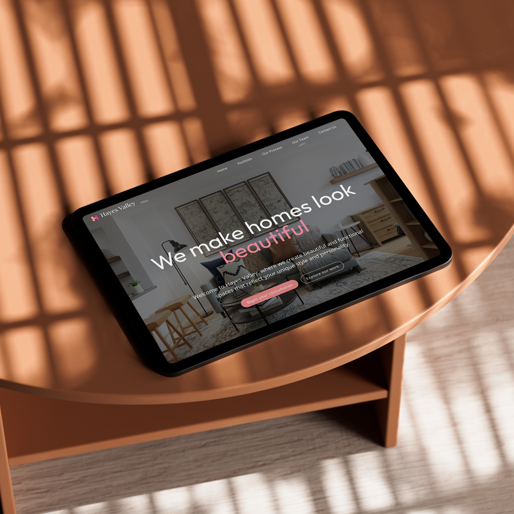 Tablet on an orange table displaying a website homepage for Hayes Valley interior design, featuring a modern living room and text saying 'We make homes look beautiful.'