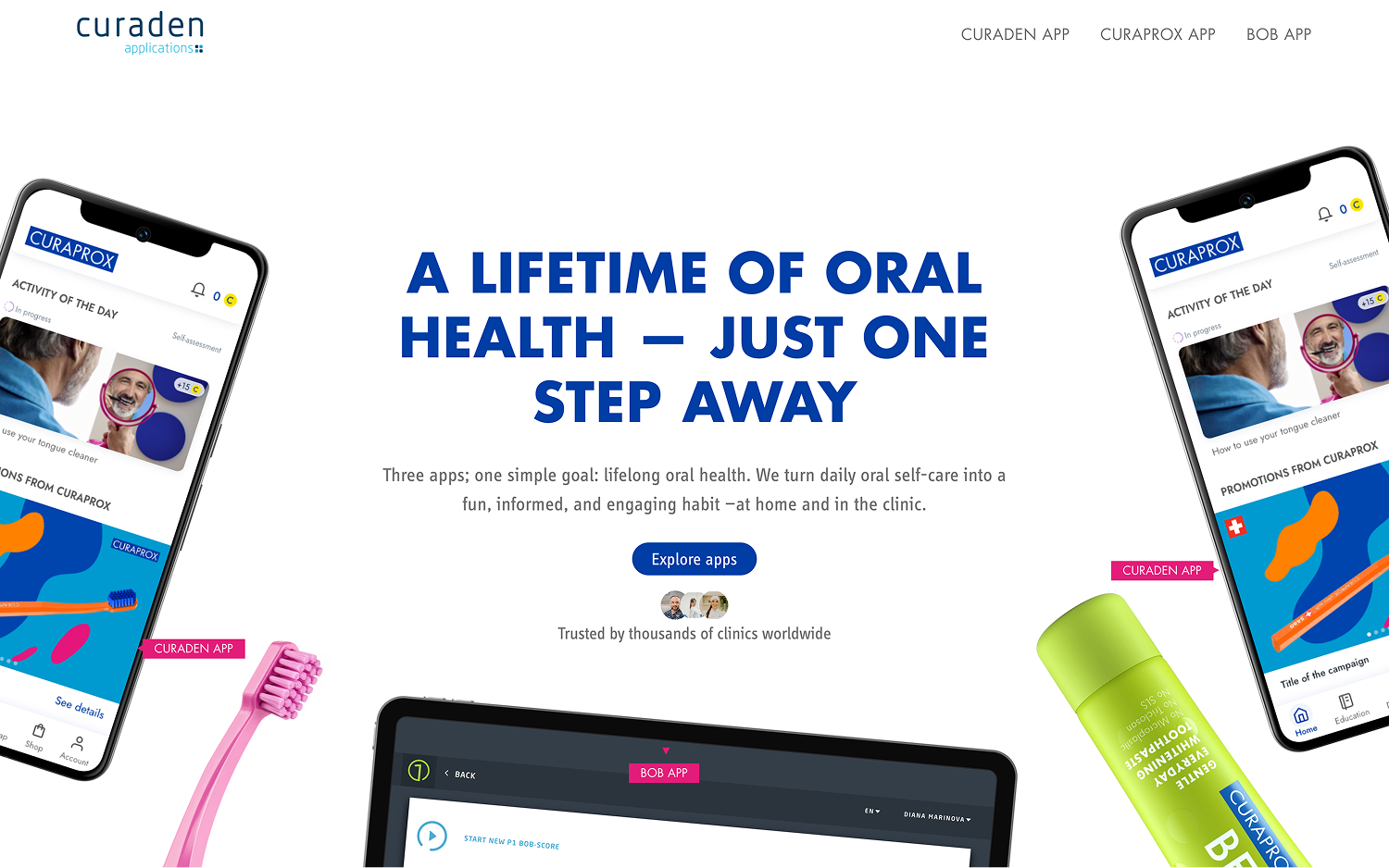 Promotional image for Curaden apps with two smartphones showing oral care app screens, a pink toothbrush, and a green Curaprox toothpaste tube, with the text 'A lifetime of oral health – just one step away' and a call to explore apps.