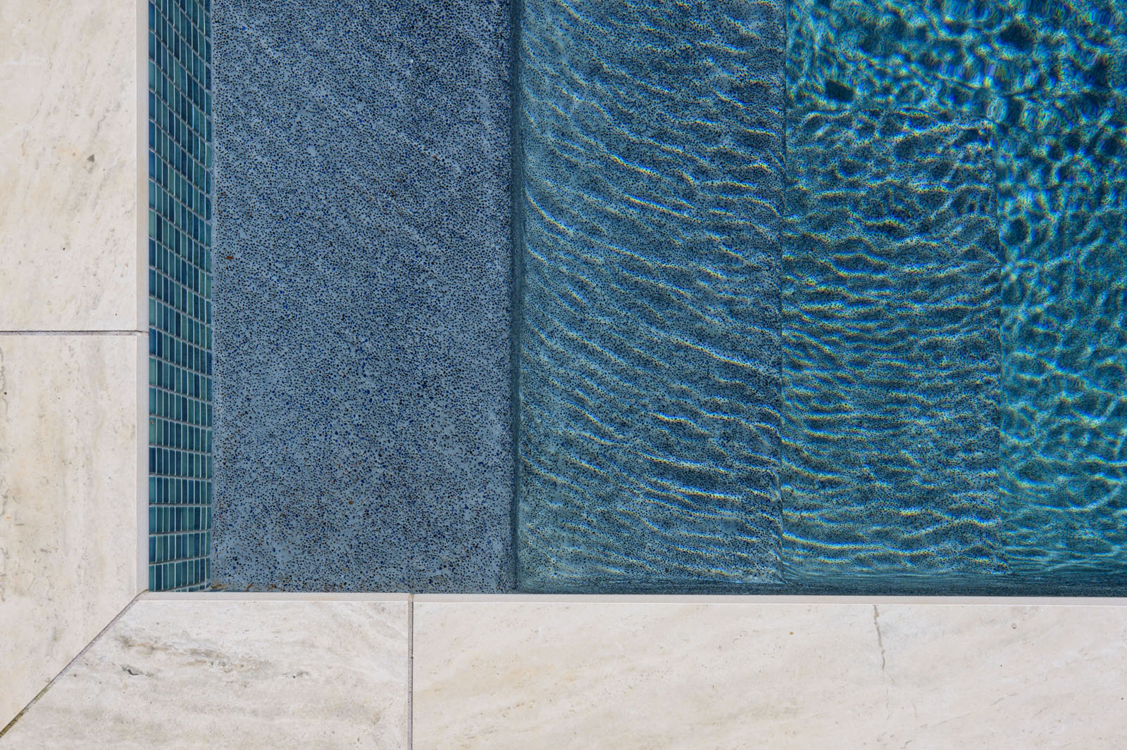 An upper closeup view of a blue water pool.