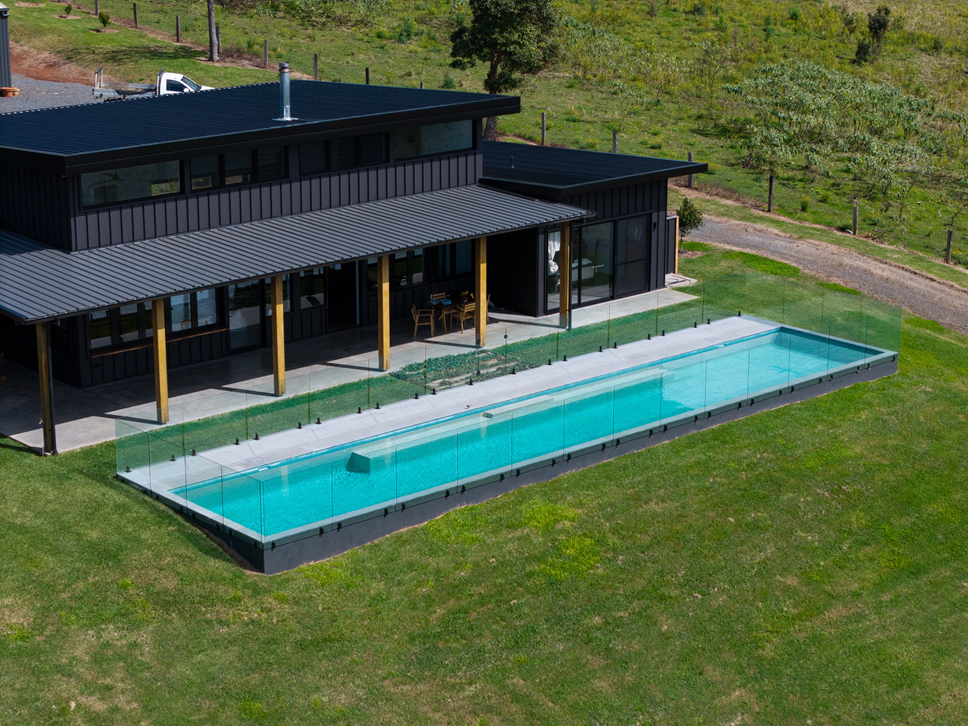 Lap pool beside a modern rural home