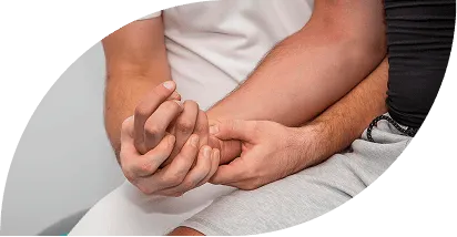 Close-up of a person gently holding another person's wrist, suggesting care or support.
