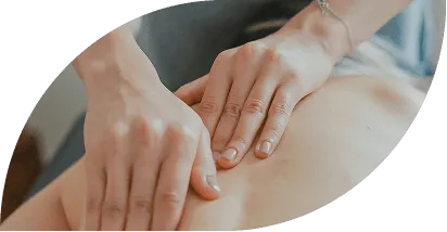 Close-up of hands performing a massage on a person's back.