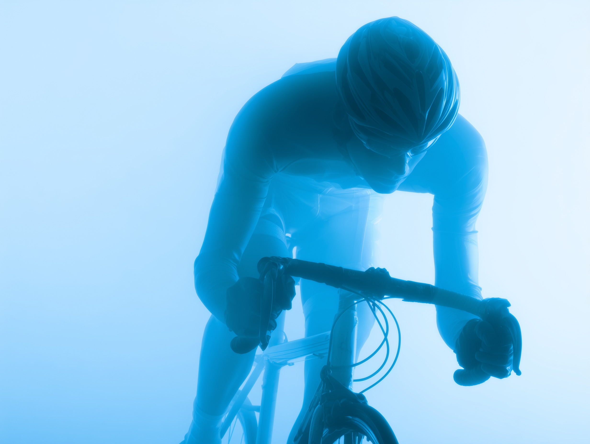 Silhouetted cyclist in aerodynamic position riding a road bike against a blue gradient background.