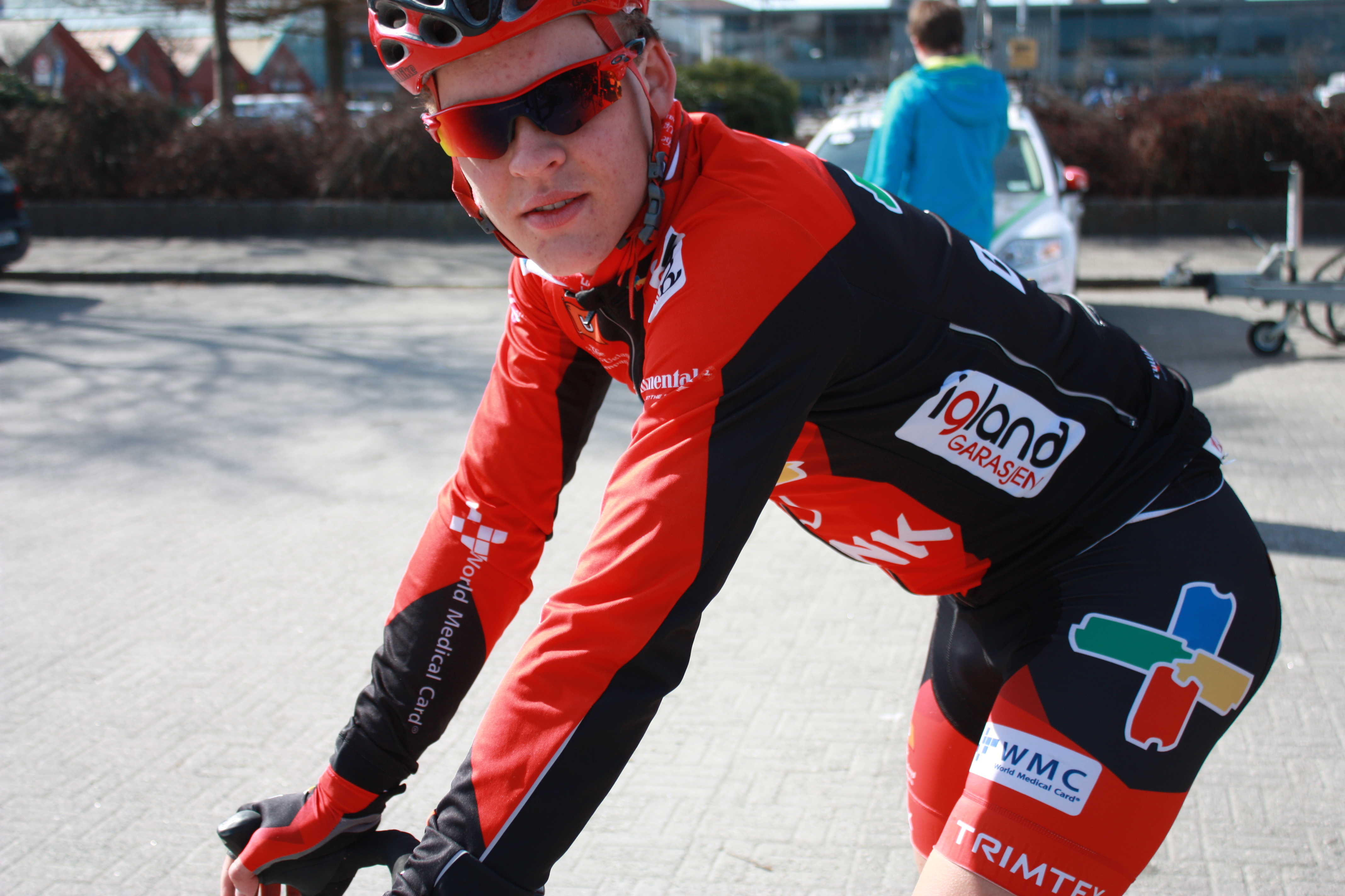 Cyclist in racing kit riding outdoors