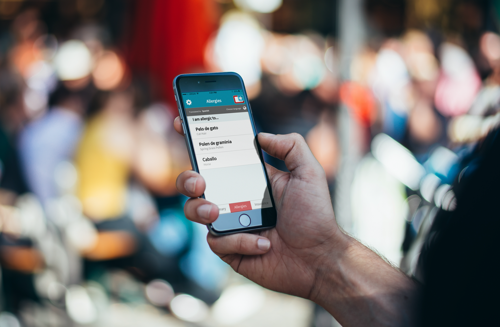 World Medical Card app on a phone in a busy crowd