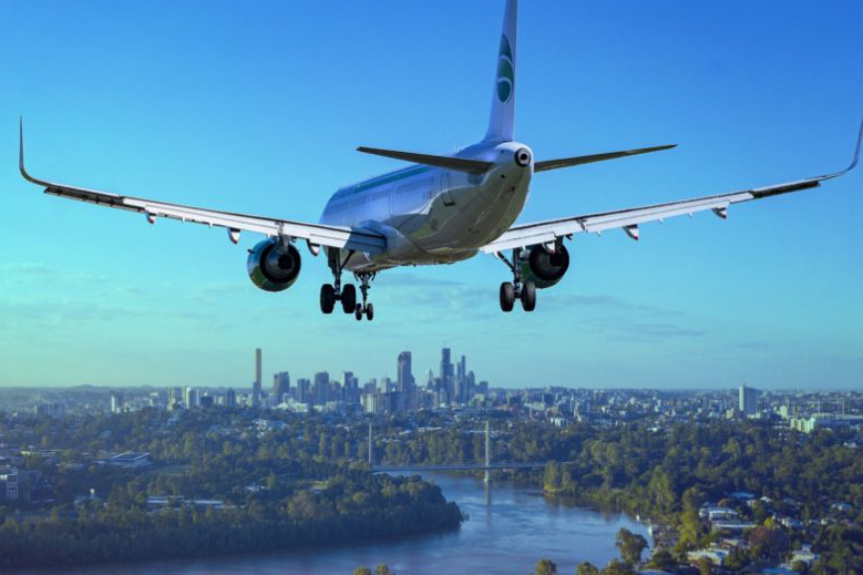 Passenger plane flying low over a city
