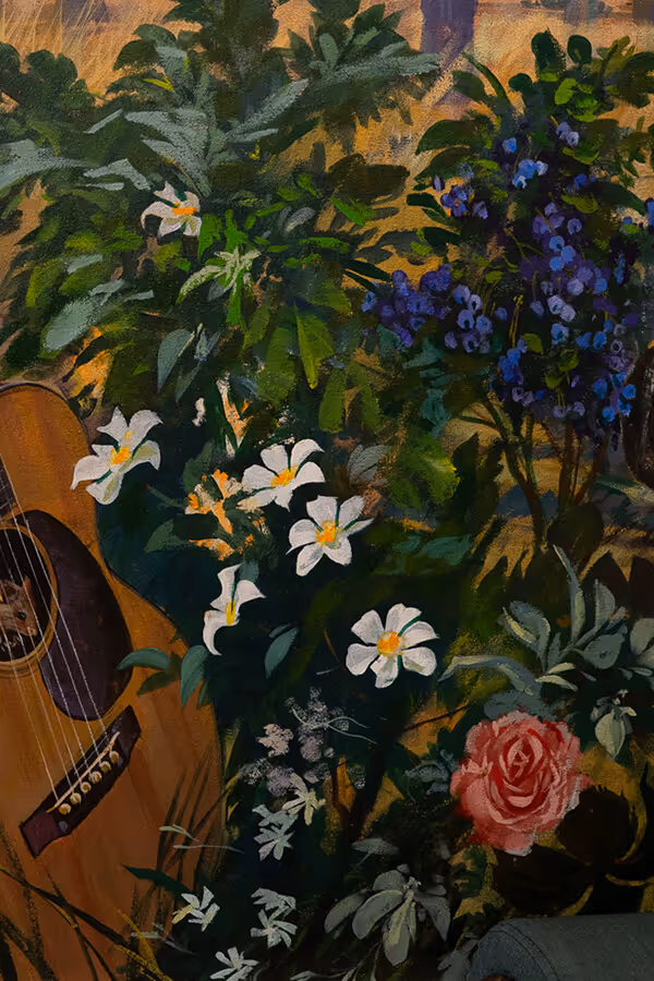 A close-up of an acoustic guitar surrounded by a variety of flowers including white blooms, purple clusters, and a single pink rose against a textured background.