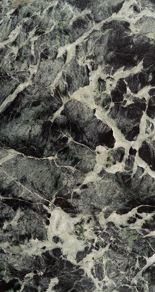 Close-up of dark green and black marble surface with white and light green veining.