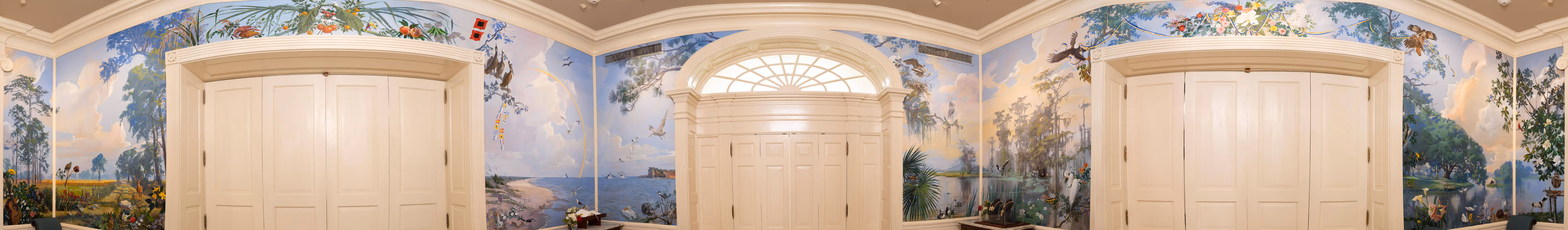 Panoramic view of an ornate room with large double doors and walls painted with detailed nature murals featuring birds, trees, flowers, and a waterfront scene.
