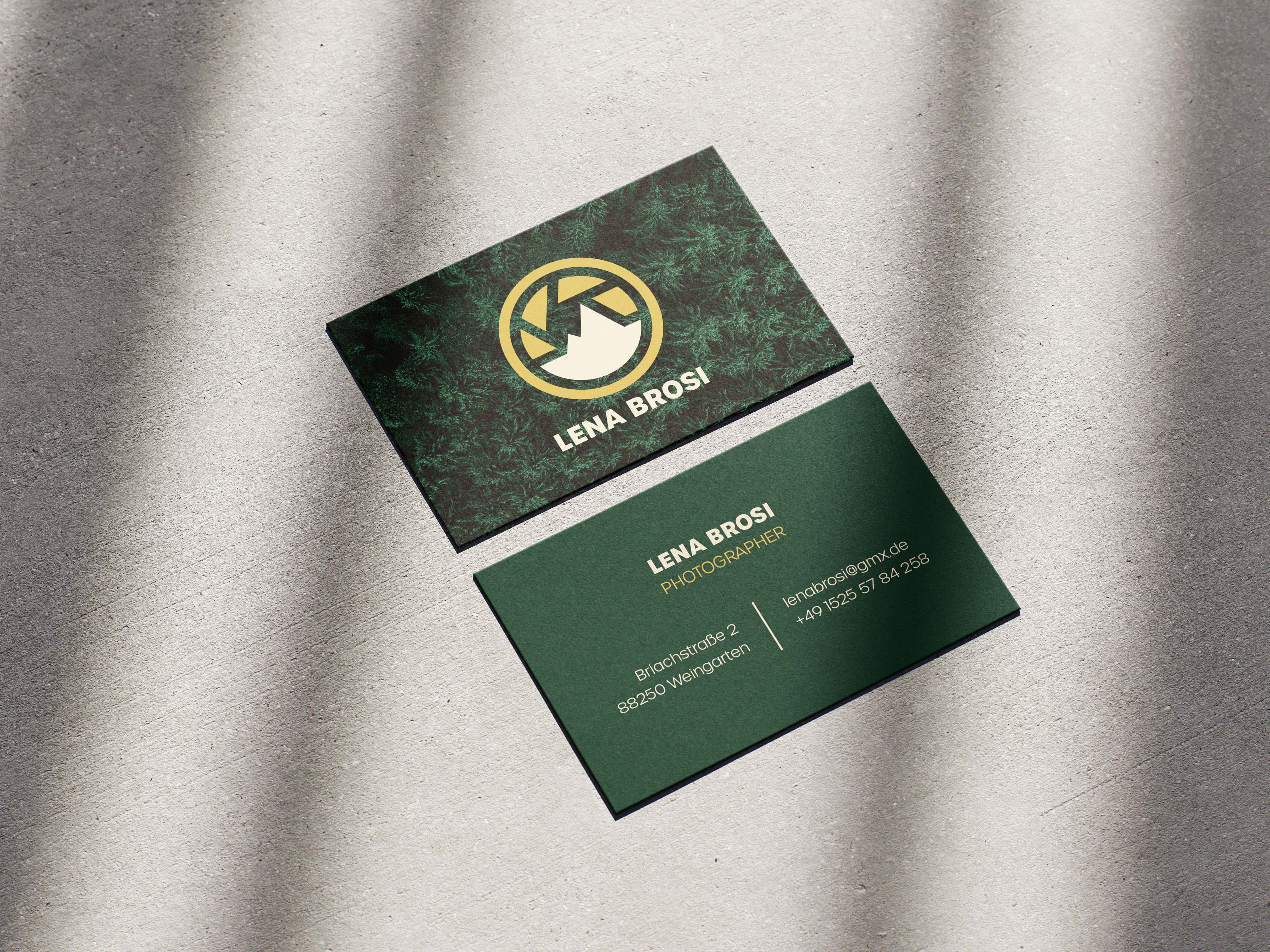 Two green business cards for photographer Lena Brosi on a textured surface, one showing a stylized logo and name, the other contact details including email and phone number.