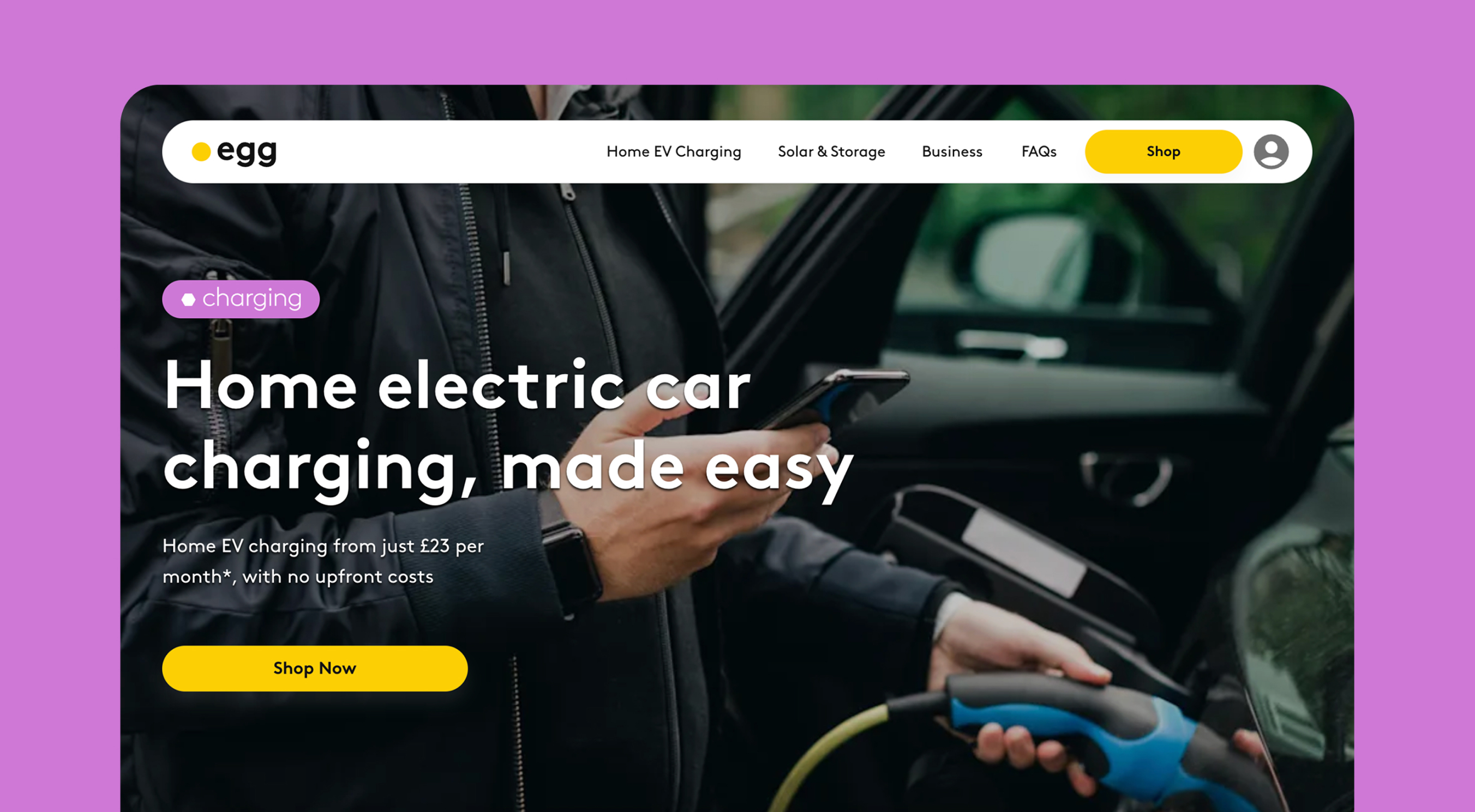 Person holding a phone and plugging in an electric vehicle charger at an open car door.