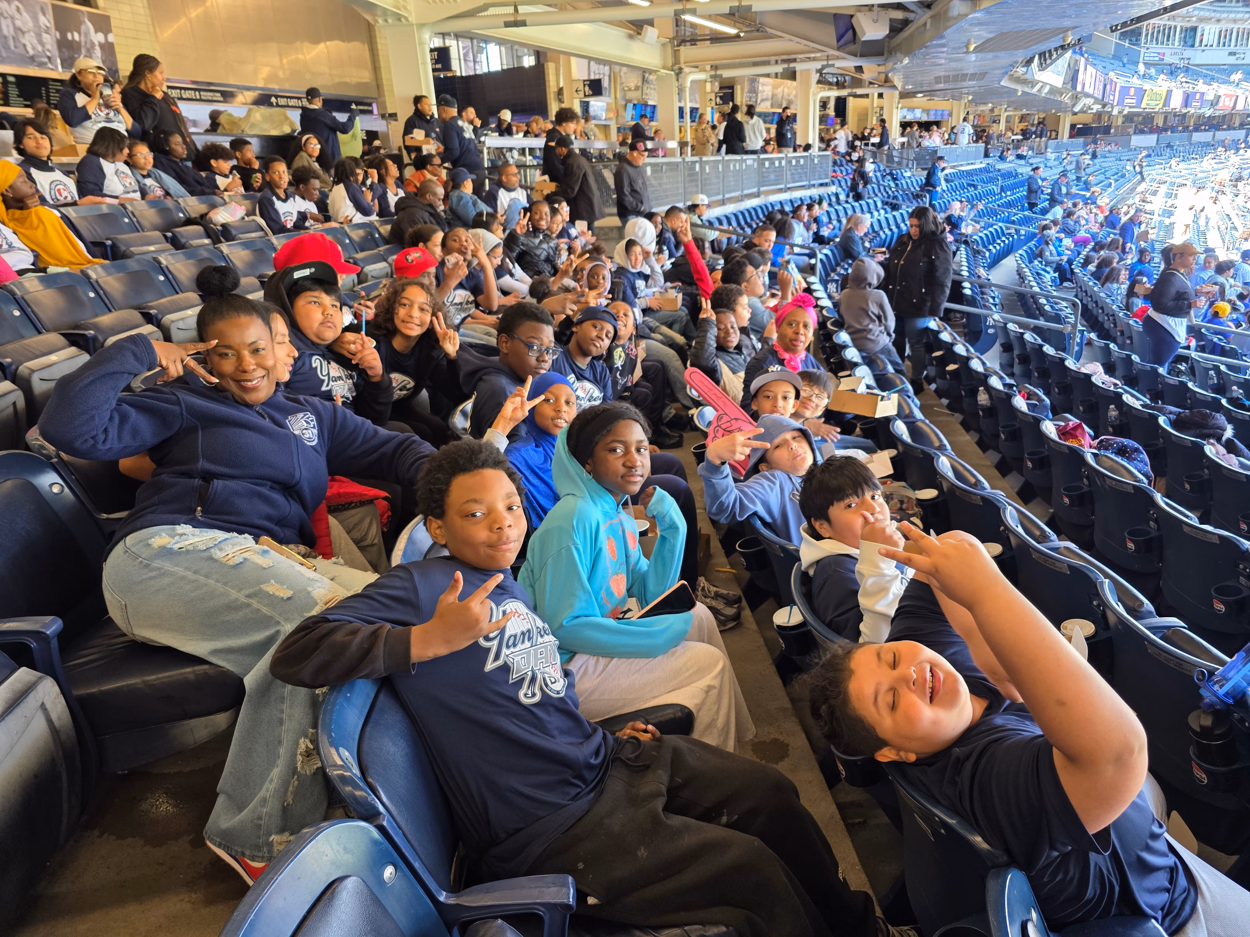 Students and chaperones seated together at Yankee Stadium field trip