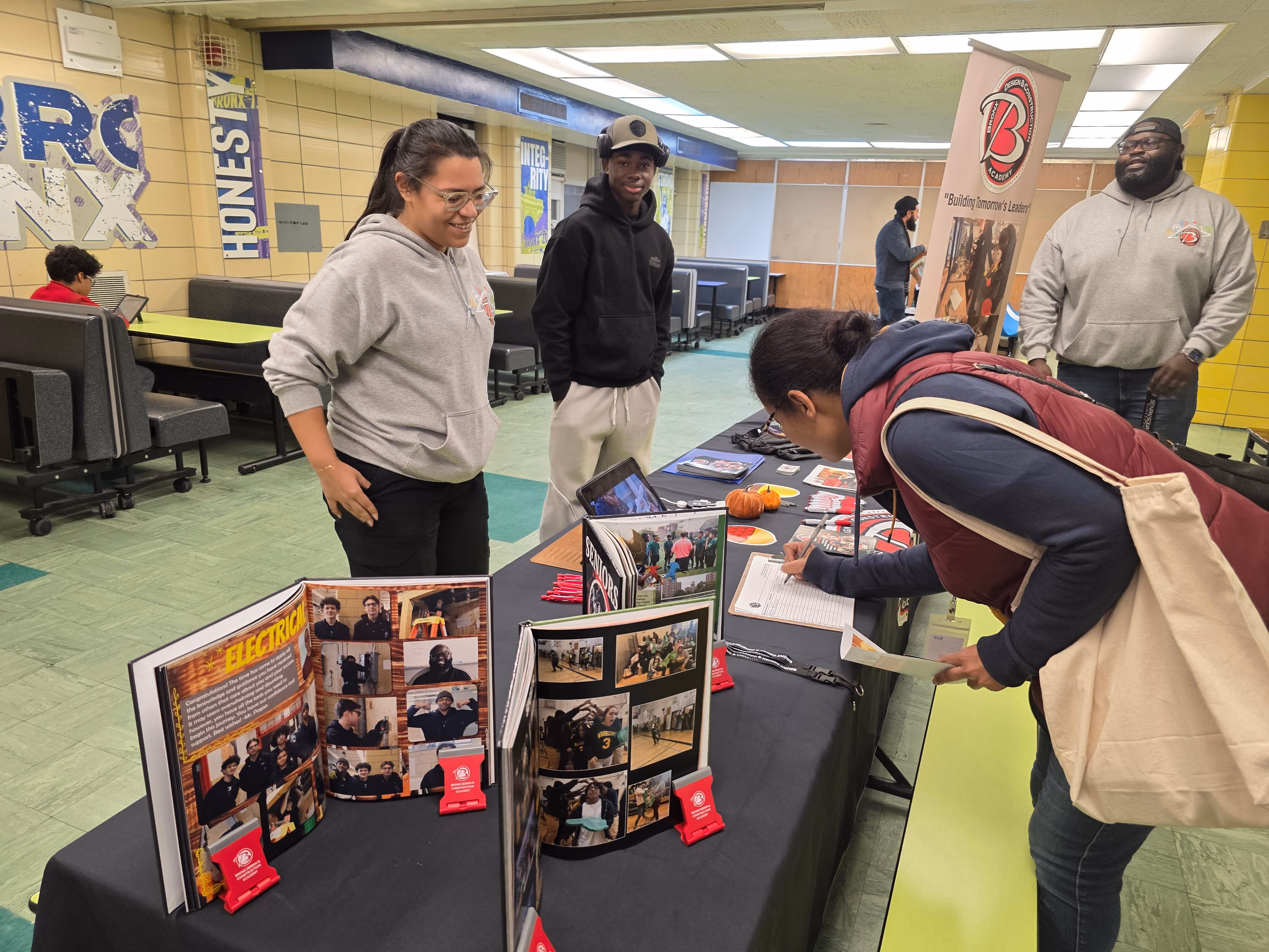 Student signing up at school information fair display table