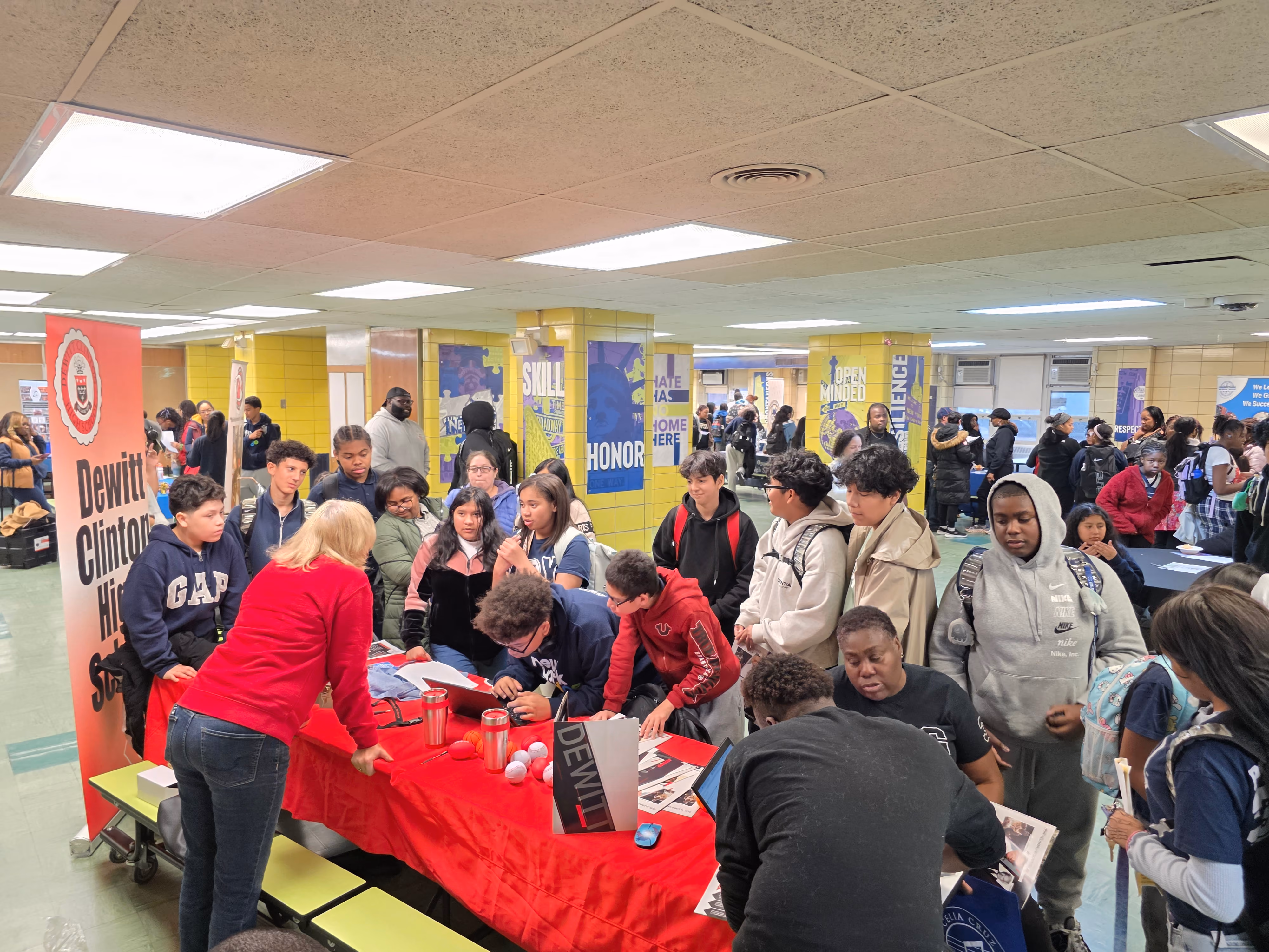 Students gathering at a DeWitt Clinton High School college fair table
