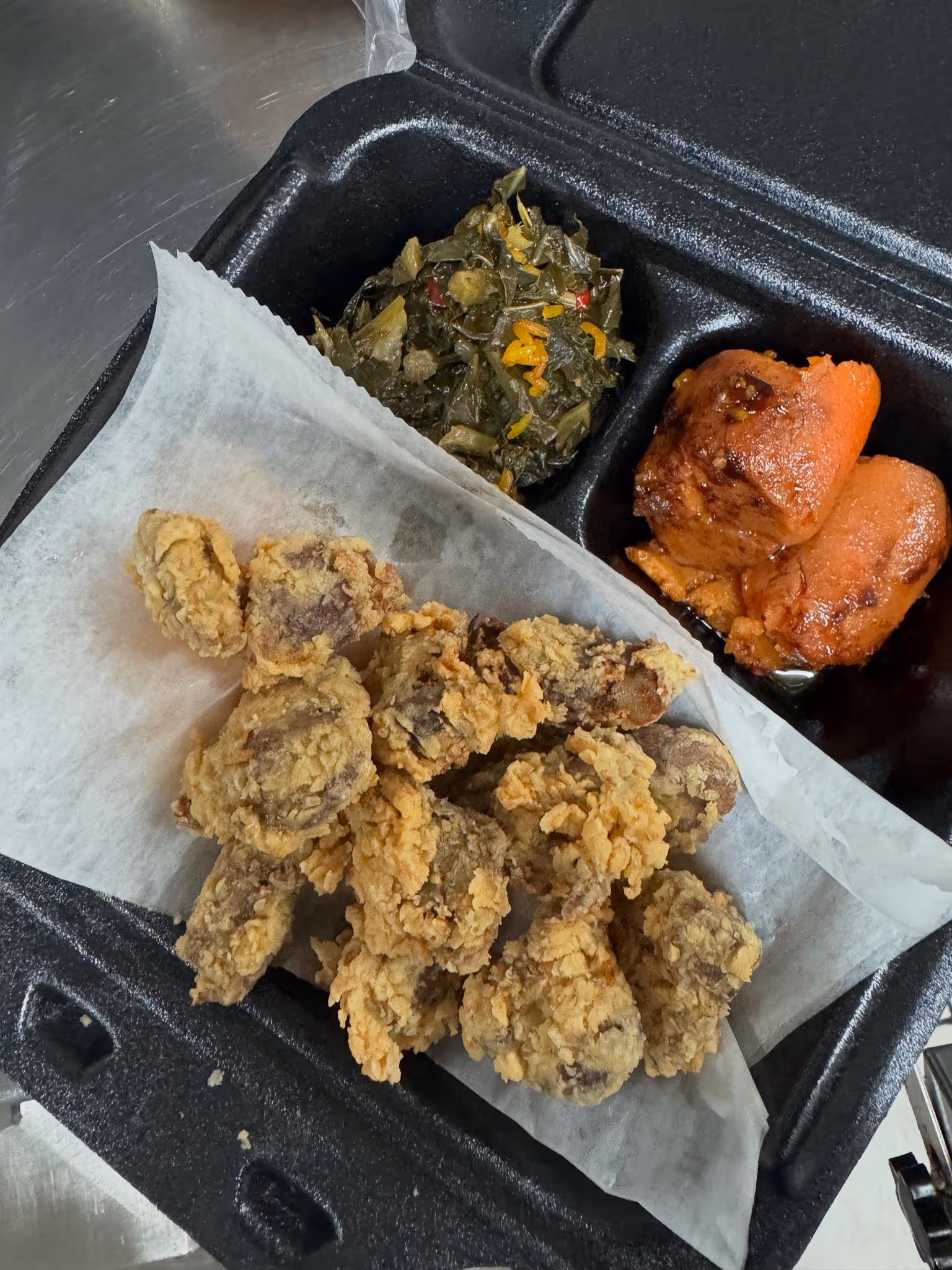 A box of fried chicken and vegetables.