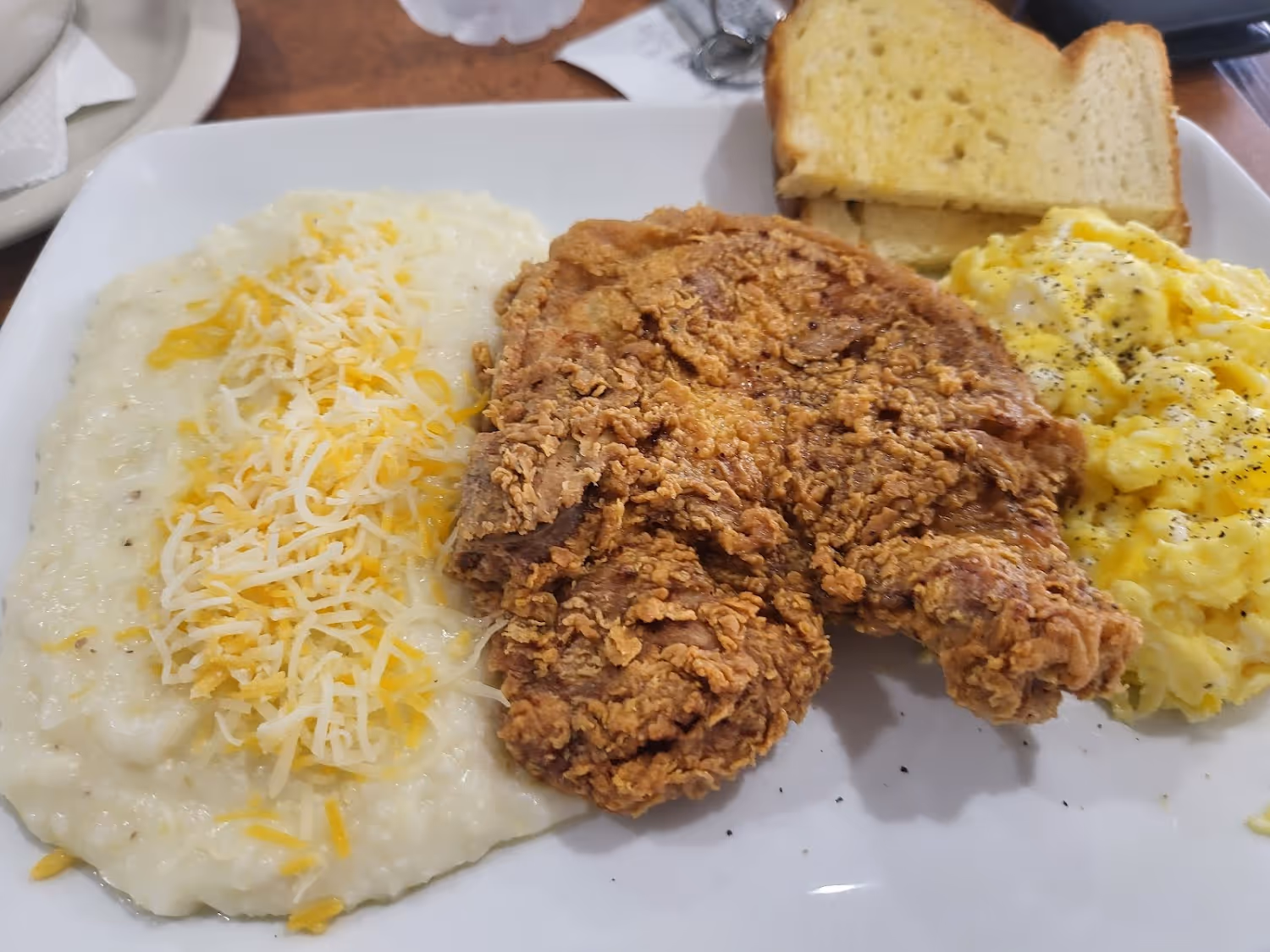 A plate of food with chicken, bread, and cheese.