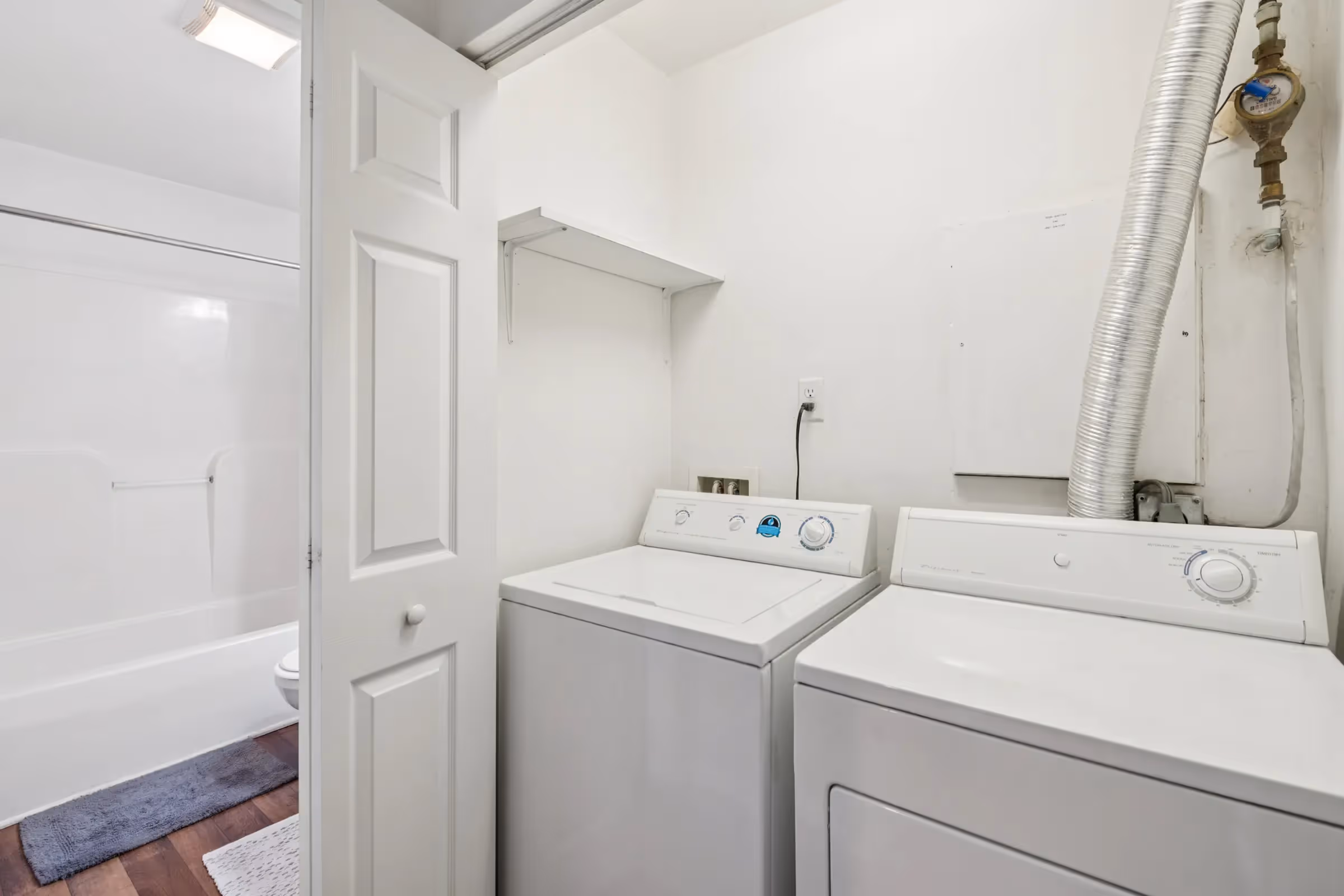 bathroom with laundry room with washer and dryer