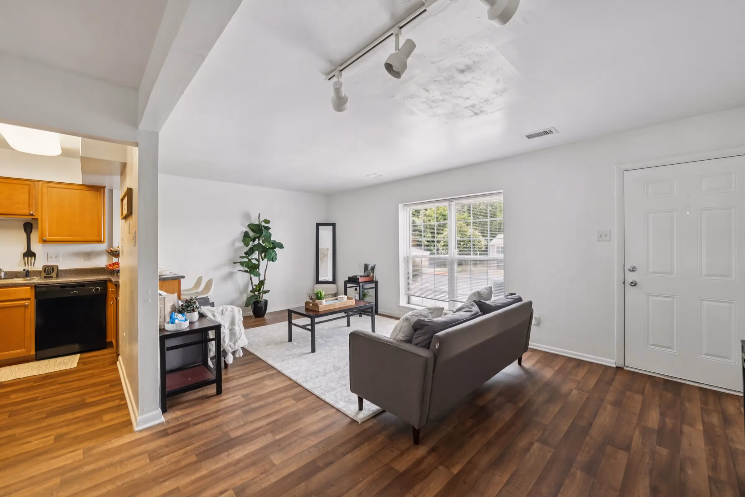 living area with sofa and view into kitchen