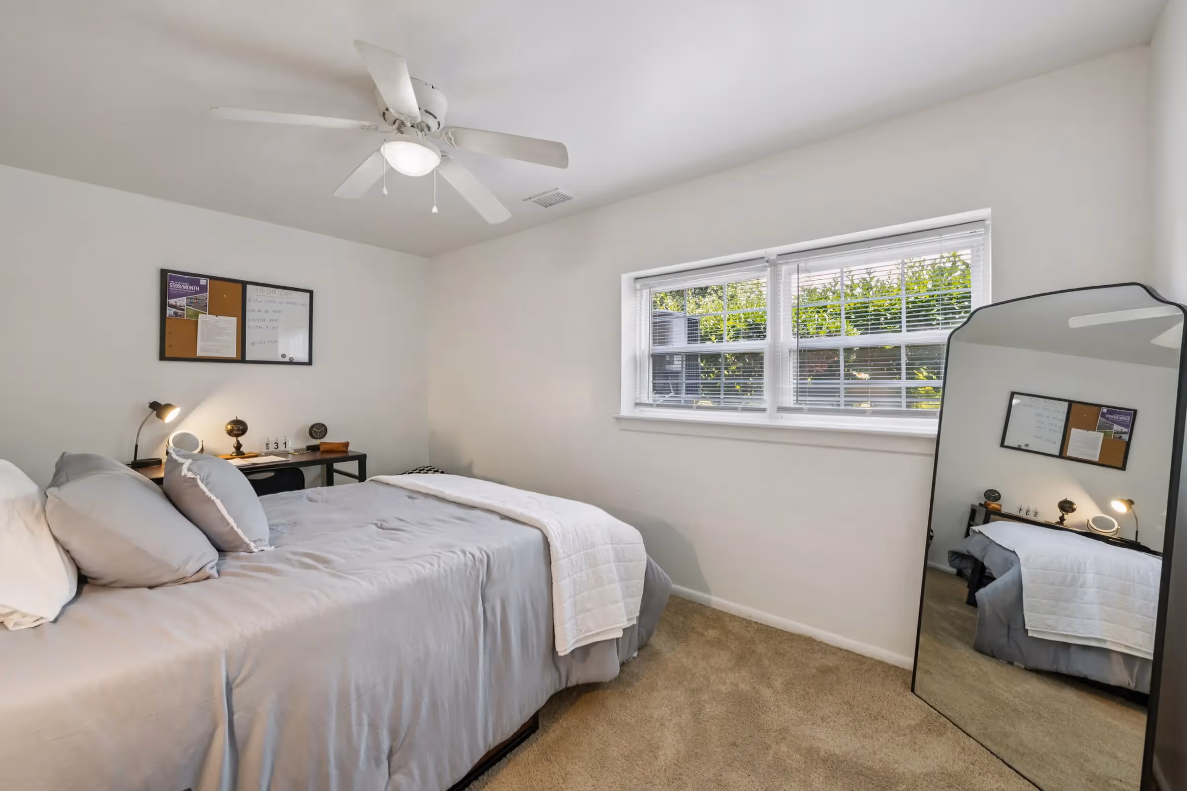 furnished bedroom with bed and desk