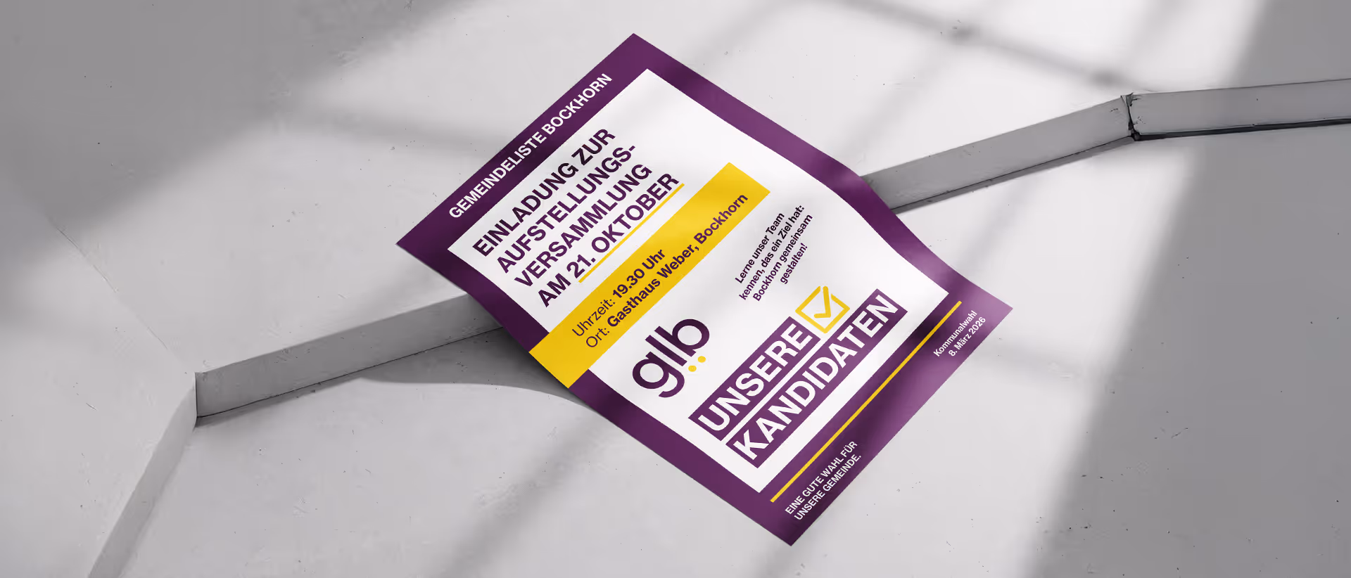 A purple and white flyer with yellow highlights inviting to a candidate meeting on October 21st at Gasthaus Weber, Bockhorn, laid on a gray concrete surface.