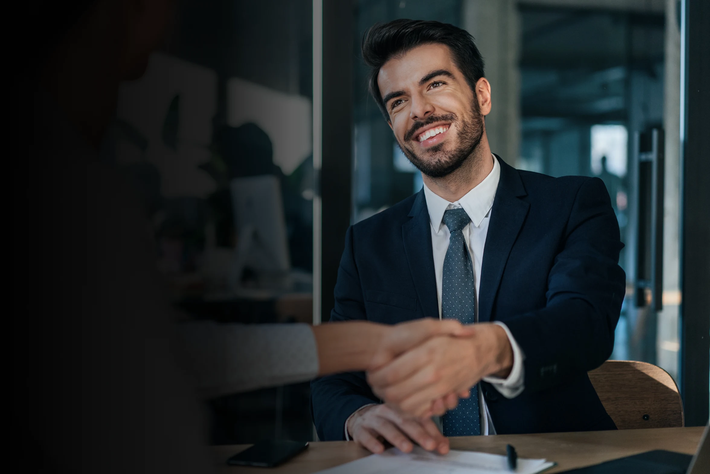 Startup founder shaking hands with an investor after successfully using DataVue to raise funding.